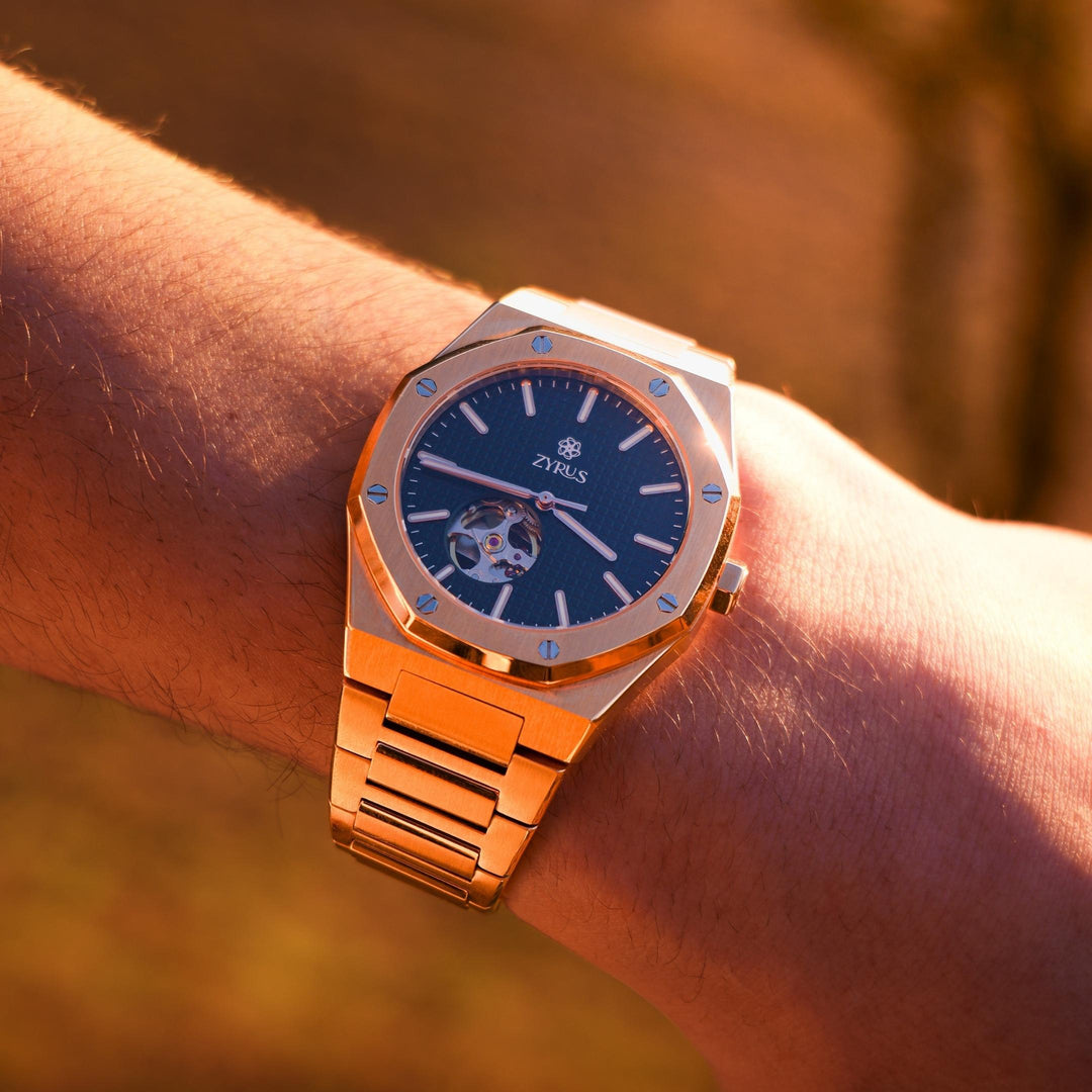 Zyrus Open Heart Watch in rose gold, beautifully highlighted against a sunset backdrop, embodying luxury and style.