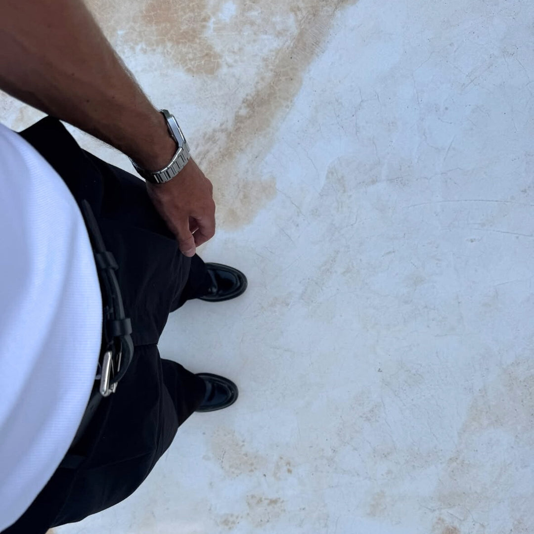 Man wearing a Zyrus silver Aperture watch in a lifestyle setting.